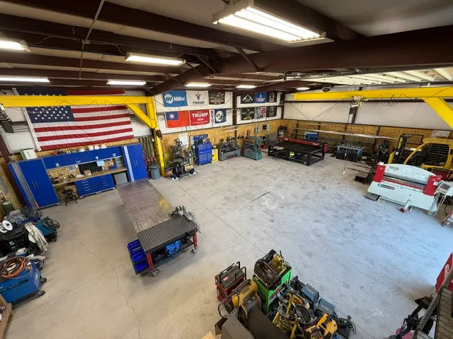 Freedom Fabrication shop interior showing welding equipment, tools, and workspace