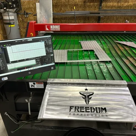 CNC plasma cutting table with freshly cut steel parts