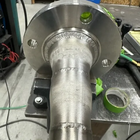 Welded flange on pipe shaft, clean weld bead