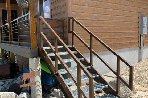Finished stair railing built by Freedom Fabrication for the Whiting cabin