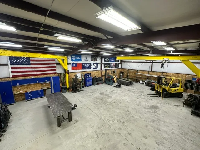 Freedom Fabrication shop interior showing welding equipment, tools, and workspace
